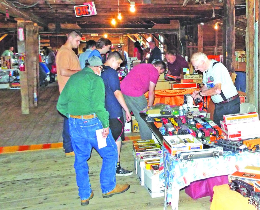 Toy train collectors and model railroaders peruse the offerings of the vendors at the museum’s annual train show. Dave Hamilton photo.
